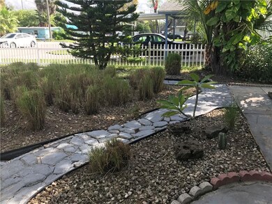Pretty stone walkway and Florida friendly front ya