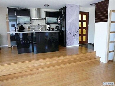 VIEW OF ENTRY, KITCHEN AND DINING AREA FROM LIVING