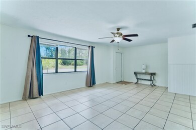 Empty room with ceiling fan and light tile pattern