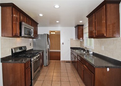 Large kitchen with stainless appliances.