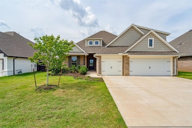 Craftsman inspired home featuring brick siding, a shingled roof, an attached garage, and driveway