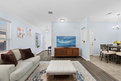 Living room with ornamental molding, dark wood-typ