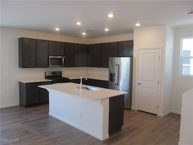 Kitchen with recessed lighting, a center island wi