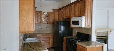Kitchen with black appliances, tasteful backsplash