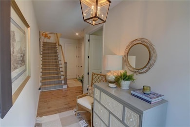 Foyer with a chandelier, light wood-type flooring,