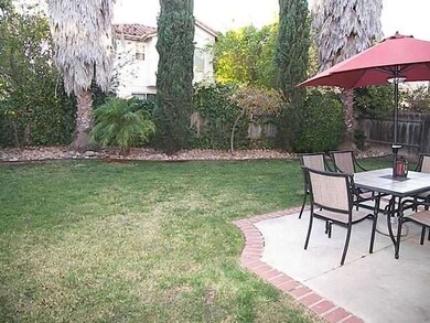Cozy backyard has a roomy patio and lawn.