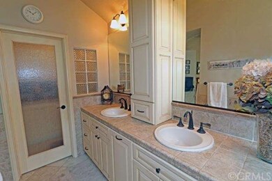 Master bathroom toilet area is separated from main bathroom by a beautiful privacy glass door.