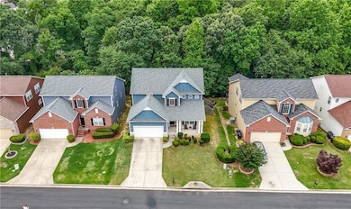 View of front facade with concrete driveway, a residential view, and a front lawn