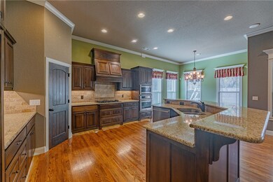 Well-equipped kitchen with pantry, gas cooktop, built-in microwave/convectional oven & bar seating.
