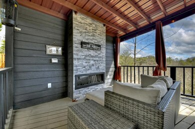Main level expanded covered deck with gas fireplac