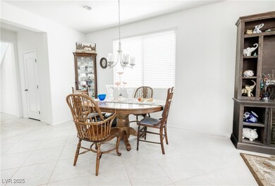 Dining space featuring a chandelier and baseboards