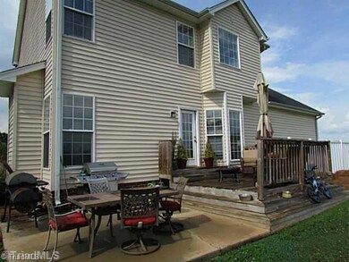 Exterior Back. Enjoy entertaining on this patio & deck overlooking 2 acres!