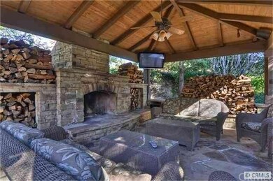 Outdoor living area with fireplace and flat panel 