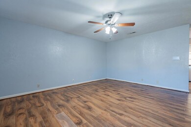 Spare room with ceiling fan and dark wood-type flo