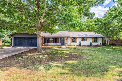Ranch-style home featuring a garage and a front la