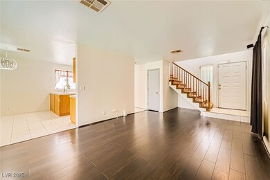 Unfurnished living room featuring stairway and woo