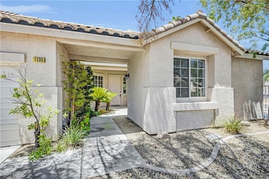 Property entrance with stucco siding and a tile ro