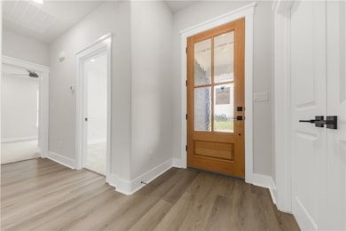 Foyer entrance with wood finished floors
