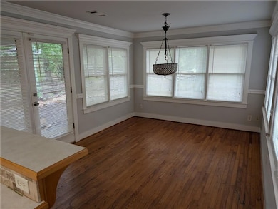 Breakfast room off kitchen with windows on 3 sides.