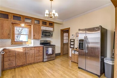 Kitchen with microwave, stove and refrigerator.