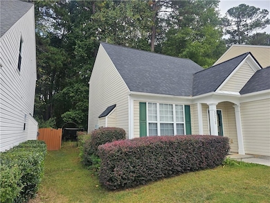 View of side of property with a shingled roof