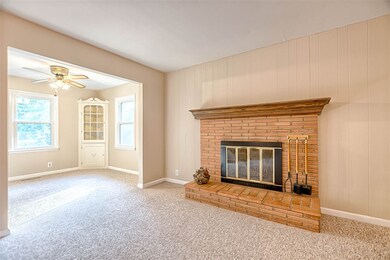 The spacious living room features a wood burning f