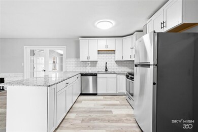 Subway tile backsplash, stainless steel kitchen.