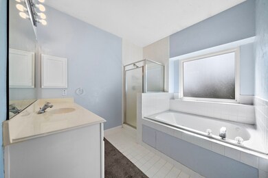 The primary ensuite bath comes complete with tile