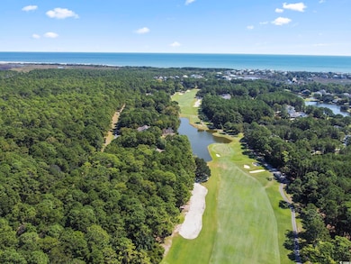 Aerial view of property's location with a large body of water and a golf course