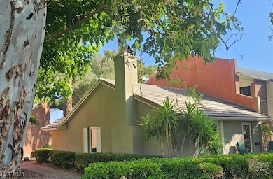 View of home's exterior with a chimney and a tile