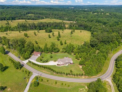 Aerial view of property's location with a forest
