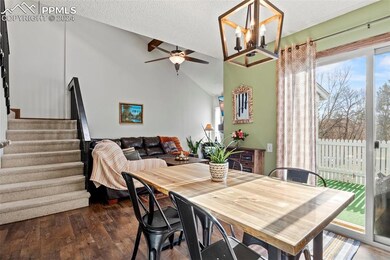 Dining room featuring lofted ceiling, dark hardwoo