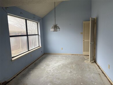 Spare room featuring vaulted ceiling and a texture