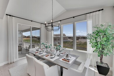Dining space featuring a chandelier, light wood-style flooring, and lofted ceiling