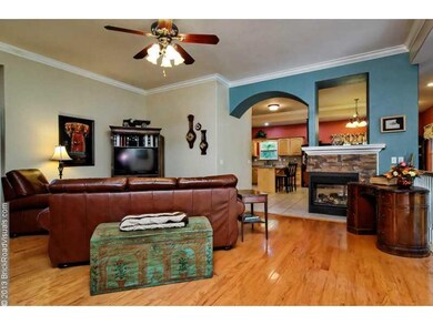 Living Room. BEAUTIFUL living room! The cutouts into the kitchen & asymmetrical fireplace give it a unique feel.