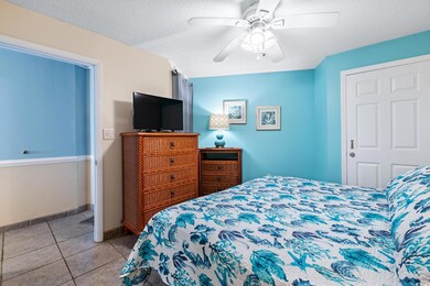 Tiled bedroom featuring a textured ceiling, ceilin