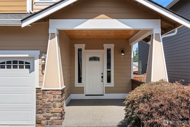 Lovely covered front porch w/wood accents!