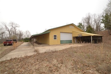Garage/shop, carport, and covered area.