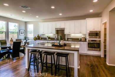 large kitchen island, quartz counter tops, stainless steel appliances