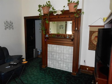 Antique fireplace mantel in living room.