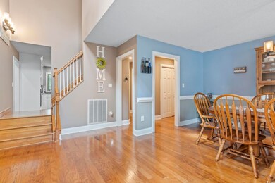 Dining room featuring visible vents, stairs, light