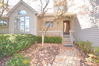 Front elevation with stone around front door and front porch great for two country rockers shaded by a large white pine and specimen boxwoods and perennials...