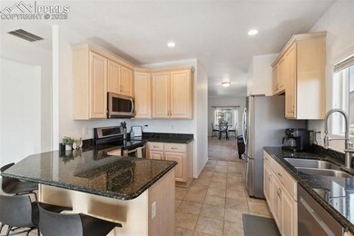 Kitchen featuring visible vents, light brown cabin