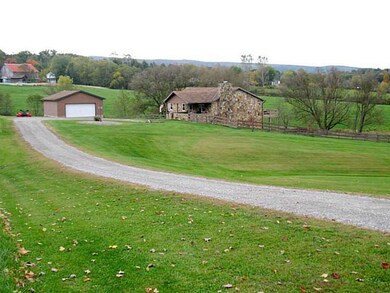 Exterior Front. Entrance from top of driveway emph