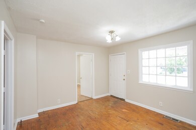 The living room retains some of the great wood floors just waiting for a little TLC
