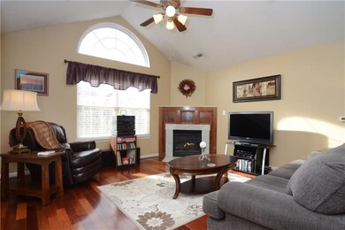 The living room includes a corner gas fireplace.
