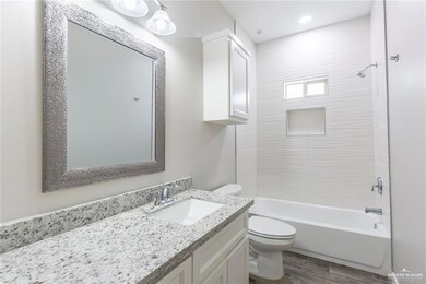 Full bathroom featuring vanity, shower / bathtub combination, and wood finished floors