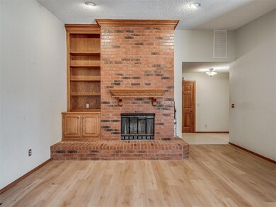 Unfurnished living room featuring a brick fireplac