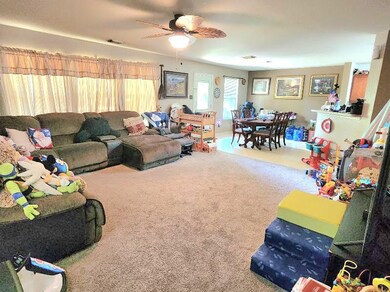 Large living room open to dining and kitchen area.