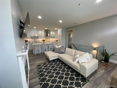 Living area featuring dark wood-style flooring and recessed lighting